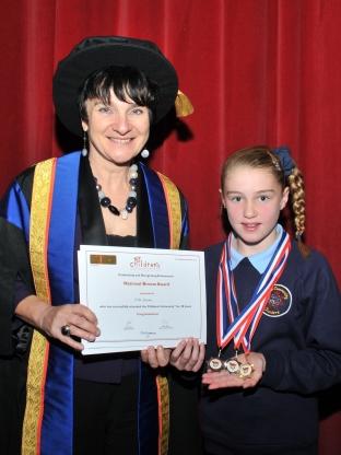 Elle Rowles, aged ten, receives her certificate from Bridgwater College principal Fiona McMillan. 