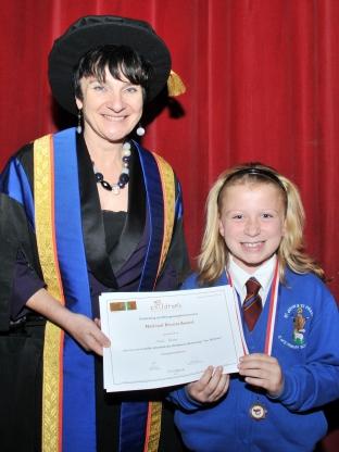 Proud pupil Katie Rowles, from St John and St Francis Primary School, receives her certificate from the night's keynote speaker, Bridgwater College principal Fiona McMillan.
