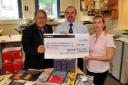 MERVYN Todd, left, presents a cheque for £125 to Nigel Betts and Karen Burt of the National Blind Children's Society. Photo: Jeff Searle