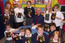 AUTHOR Joffre White signs copies of his new book, Frog, for North Newton Primary School pupils. Photo: Submitted