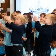 Reception class Snowy Owls celebrating being a Water School.
