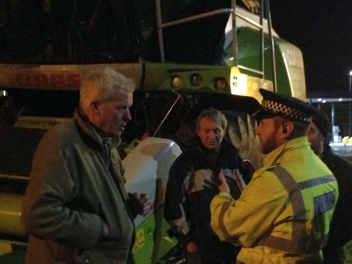 FARMERS for Action chairman, David Handley, has a word with a police officer.