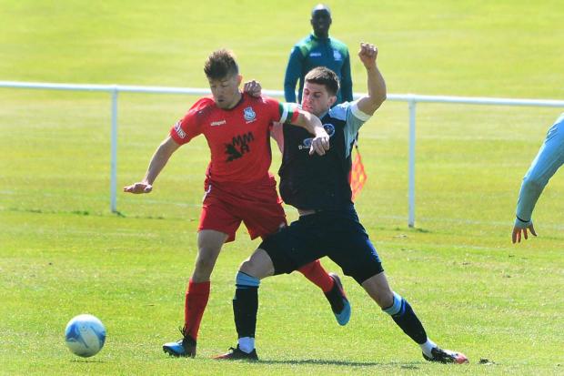 TACKLE: Ilminster Town's Louis Rutter (blue kit) challenges Street Reserves captain Olly Walby (all pics: Steve Richardson)