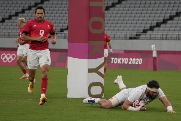 COMEBACK: Ollie Lindsay-Hague (red kit) looks on as Danny Barrett scores for the USA... but Great Britain would have the last laugh (AP Photo/Shuji Kajiyama).