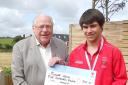 Alan Gloak, TS5C chairman, presenting a grant cheque to one of the charity's young athletes, Ronnie Wells