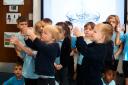 Reception class Snowy Owls celebrating being a Water School.
