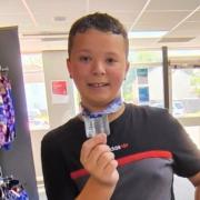 Young swimmer's 1.5km fundraising swim ends with a fractured arm